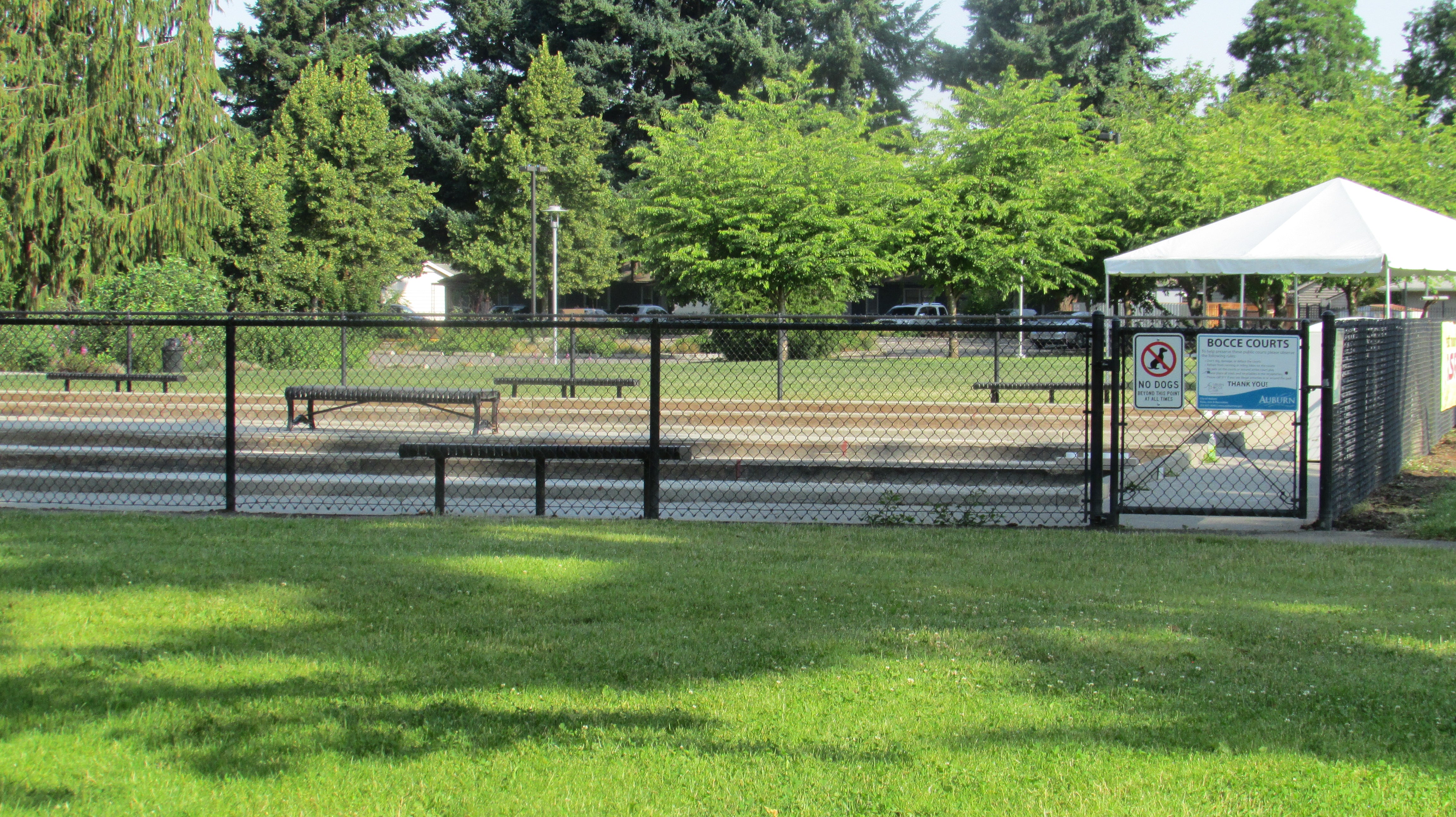 Outdoor bocce court showing oyster shell surface and wood side rails for regulation play
