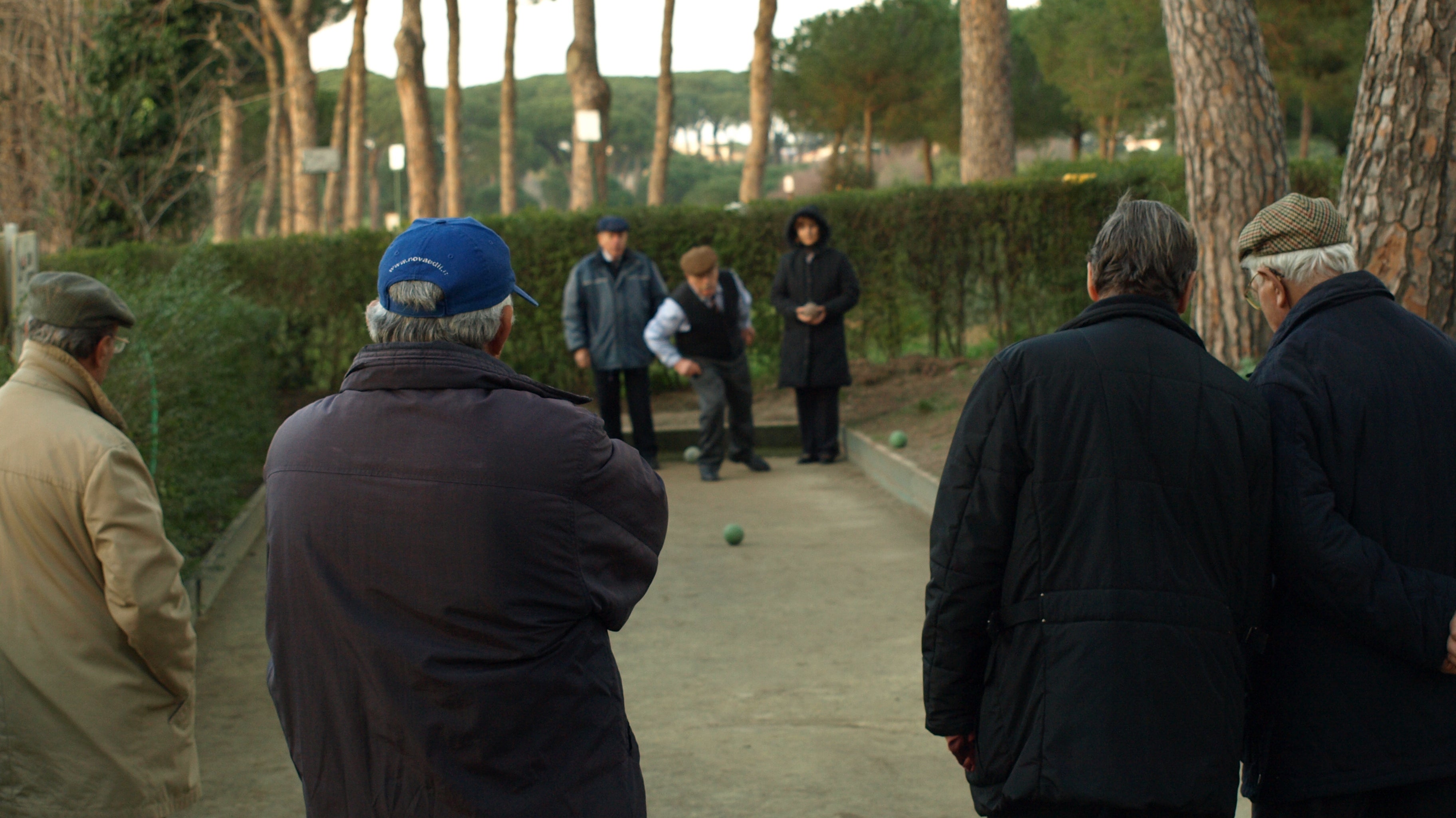 Outdoor bocce game in progress on a clay court at Villa Doria Pamphili in Rome