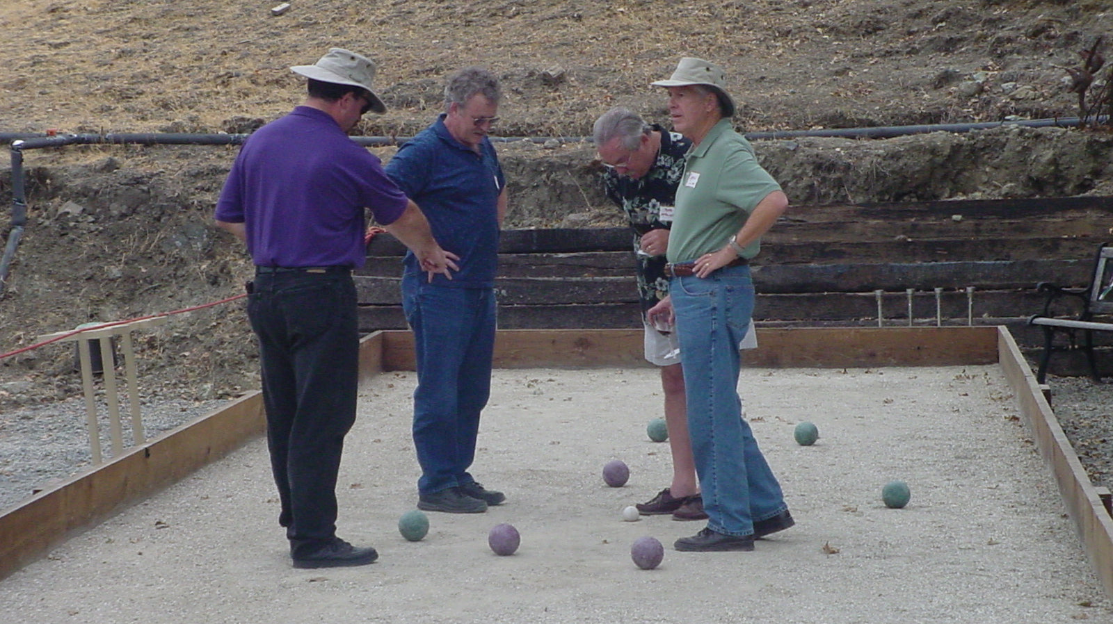 Bocce players scoring during a match on a public court in the United States