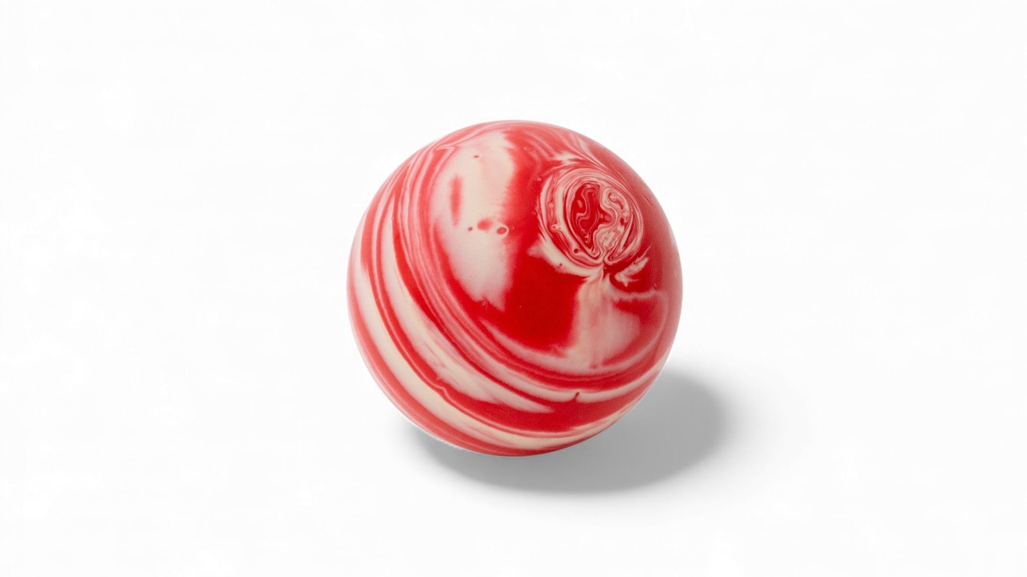 Red and white marble bocce ball close up