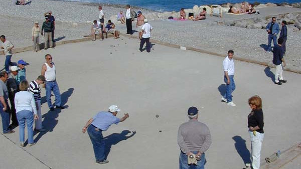 Pétanque players on a beach in Nice, France, the cultural heart of French boules tradition