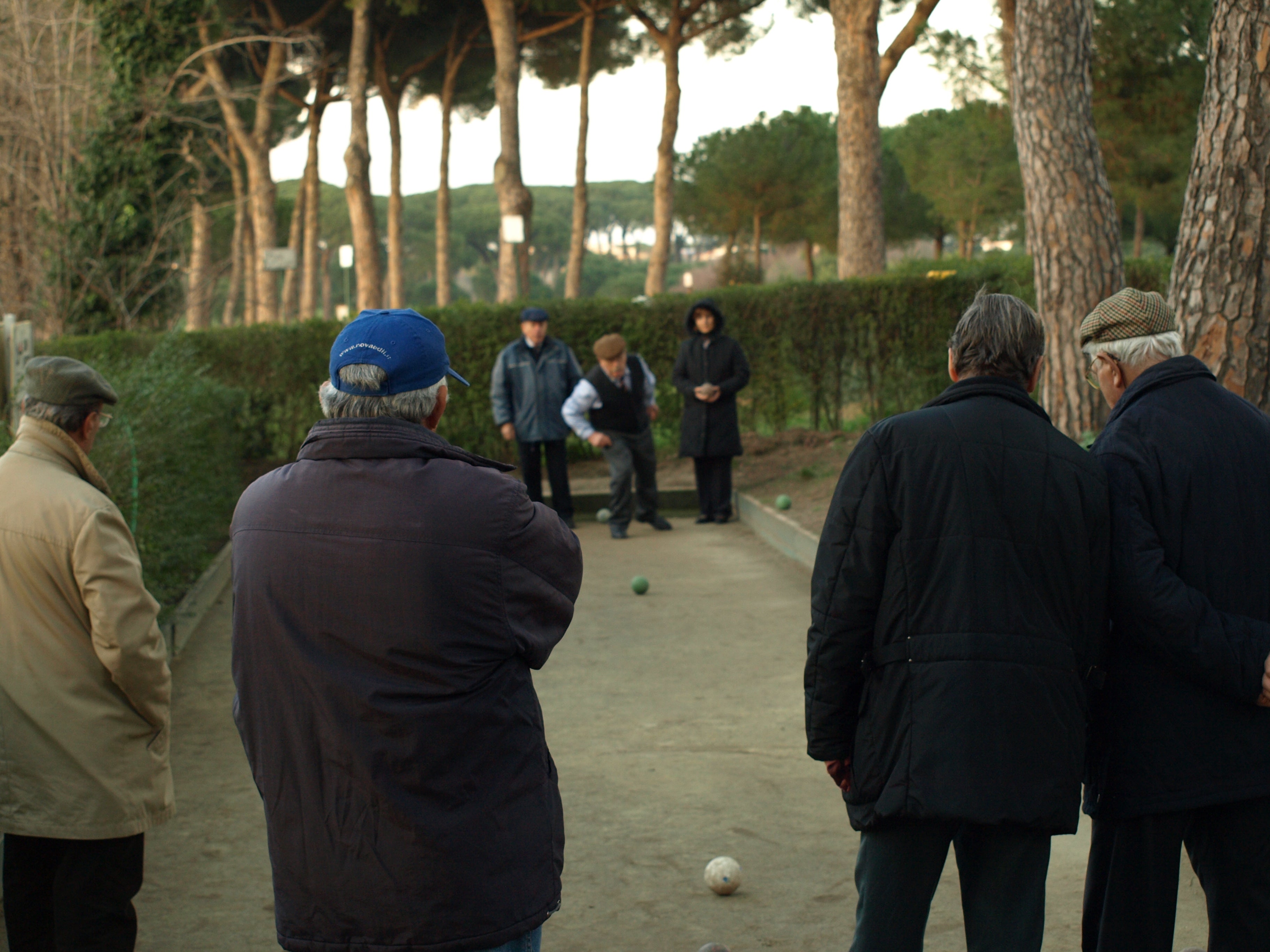 Outdoor bocce game in progress on a clay court at Villa Doria Pamphili in Rome