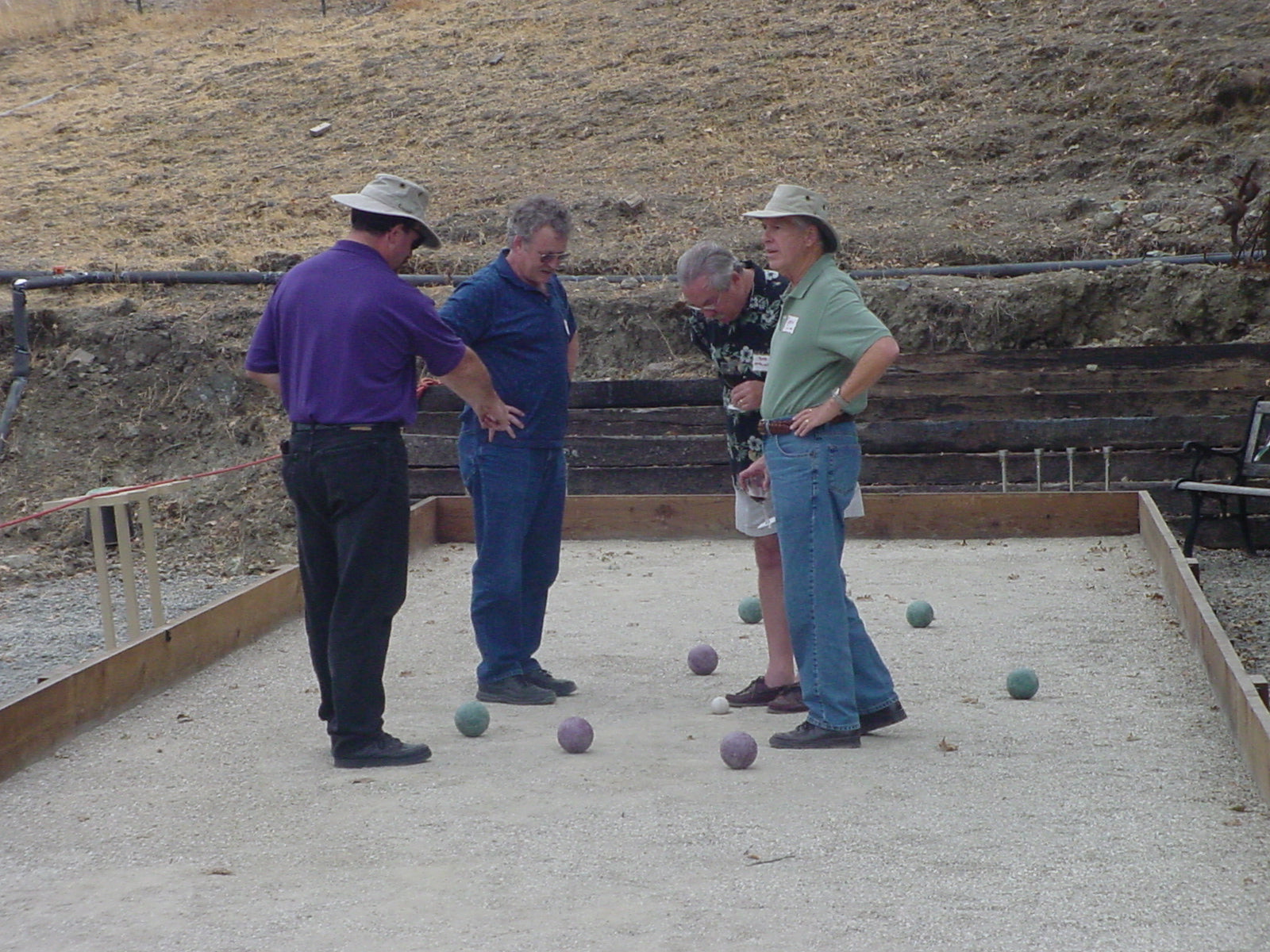 Bocce players scoring during a match on a public court in the United States