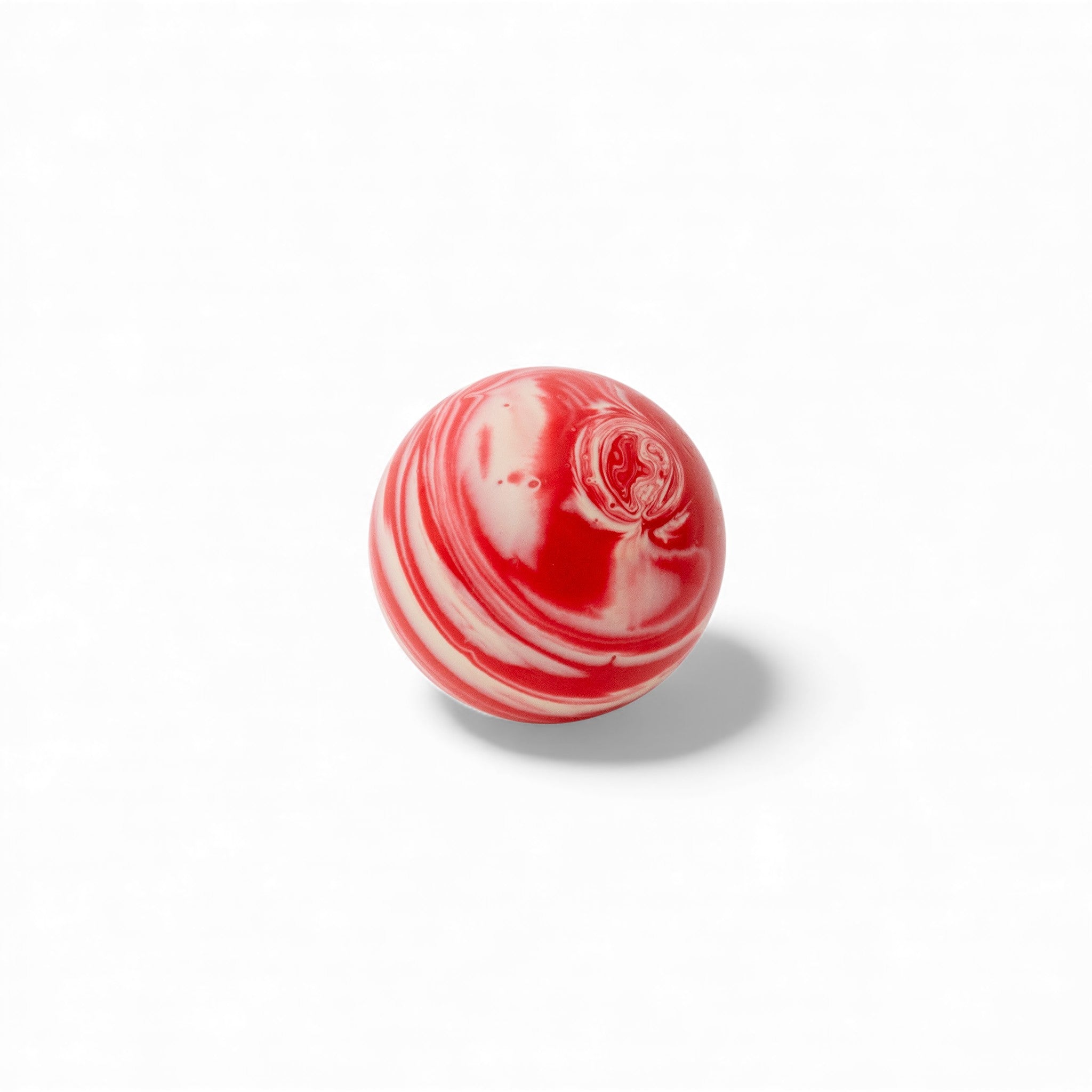 Red and white marble bocce ball close up