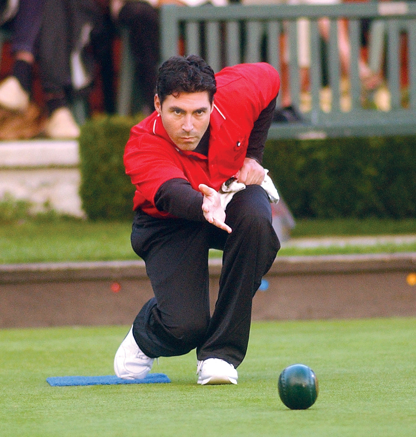 Lawn bowls player, the British cousin of bocce, illustrating the shared etiquette culture across rolling-ball sports
