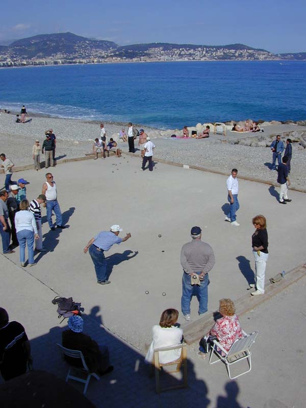 Pétanque players on a beach in Nice, France, the cultural heart of French boules tradition